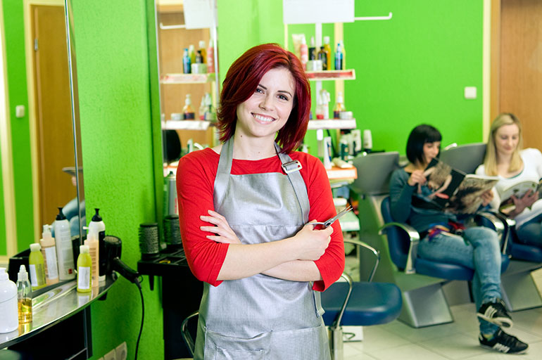 Hair stylist stand next to her chair